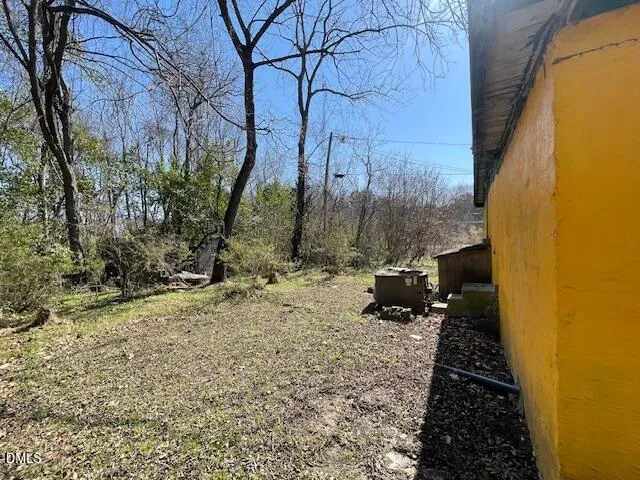 a view of a backyard of the house