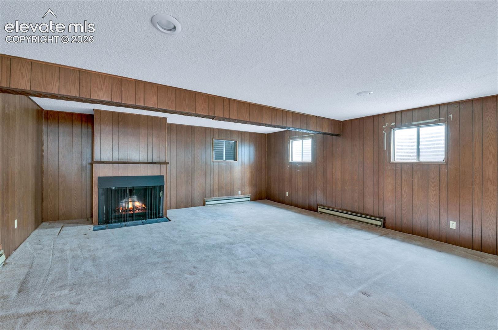 24975 Sanborn Road Calhan, CO 80808 - Photo 35 of 50 Basement family room with a fireplace