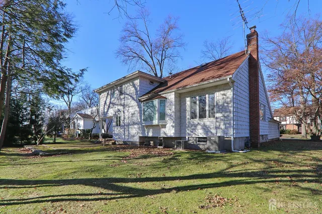 a front view of a house with a yard table and chairs