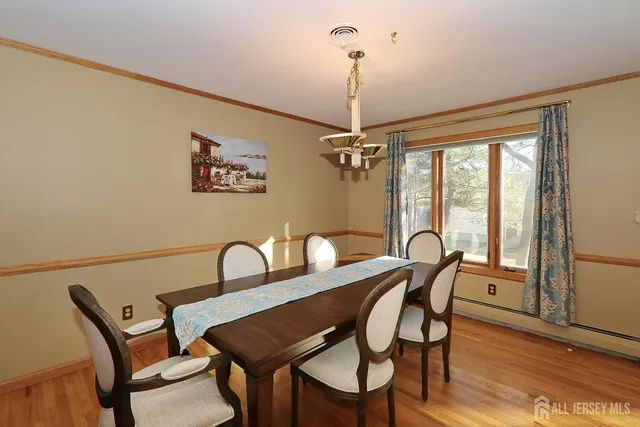 a view of a dining room with furniture window and wooden floor