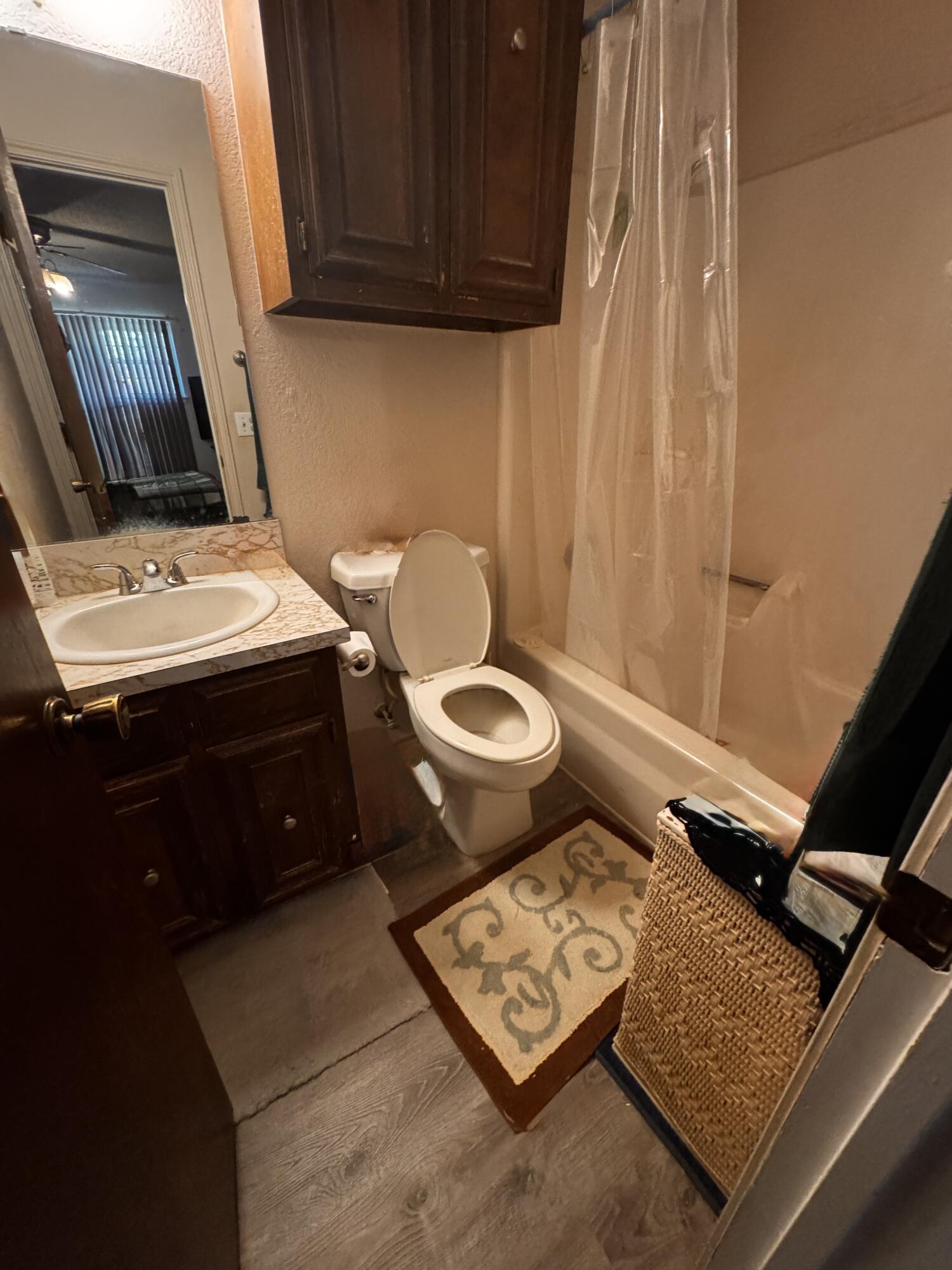3902 Sides Street Plainview, TX 79072 - Photo 13 of 26 a bathroom with a sink toilet and vanity