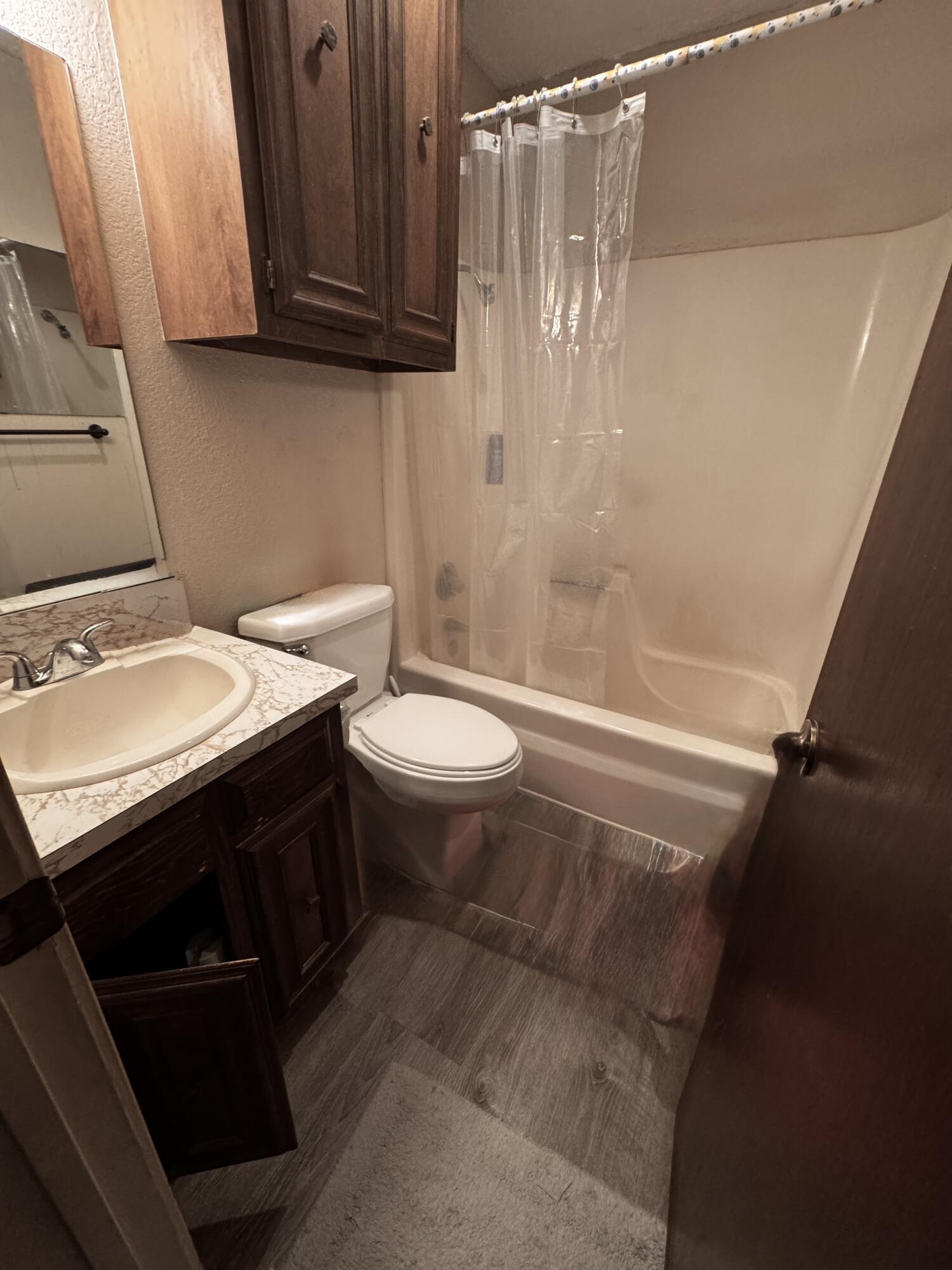 3902 Sides Street Plainview, TX 79072 - Photo 16 of 26 a bathroom with a sink a toilet and shower