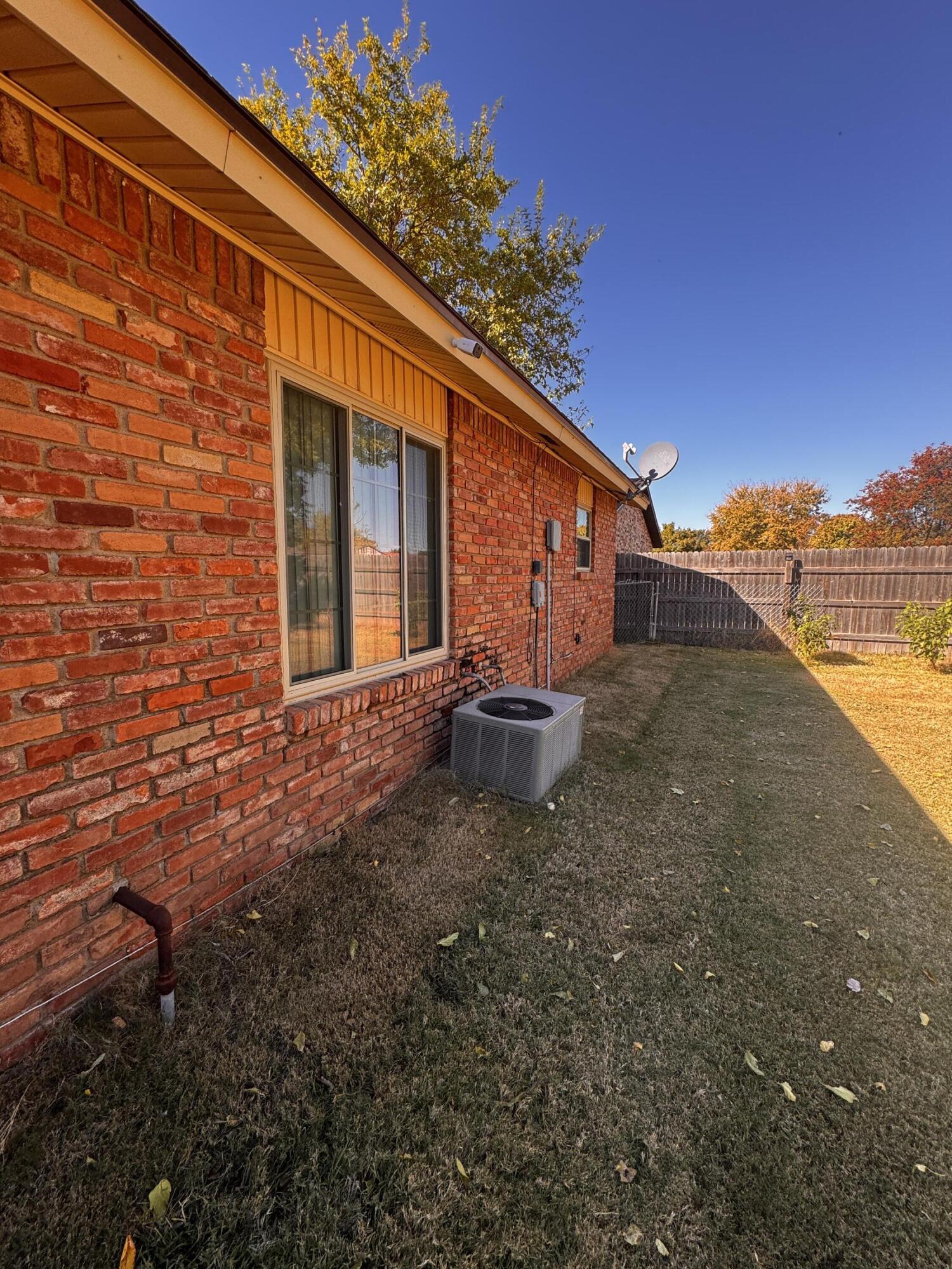 3902 Sides Street Plainview, TX 79072 - Photo 21 of 26 a view of a backyard with plants and large tree