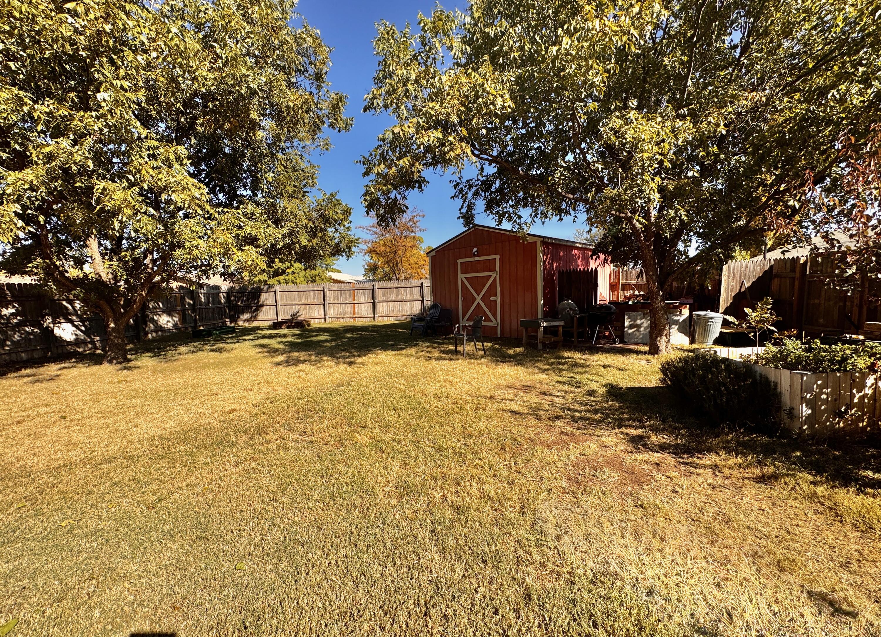 3902 Sides Street Plainview, TX 79072 - Photo 22 of 26 a view of a yard with trees in the background
