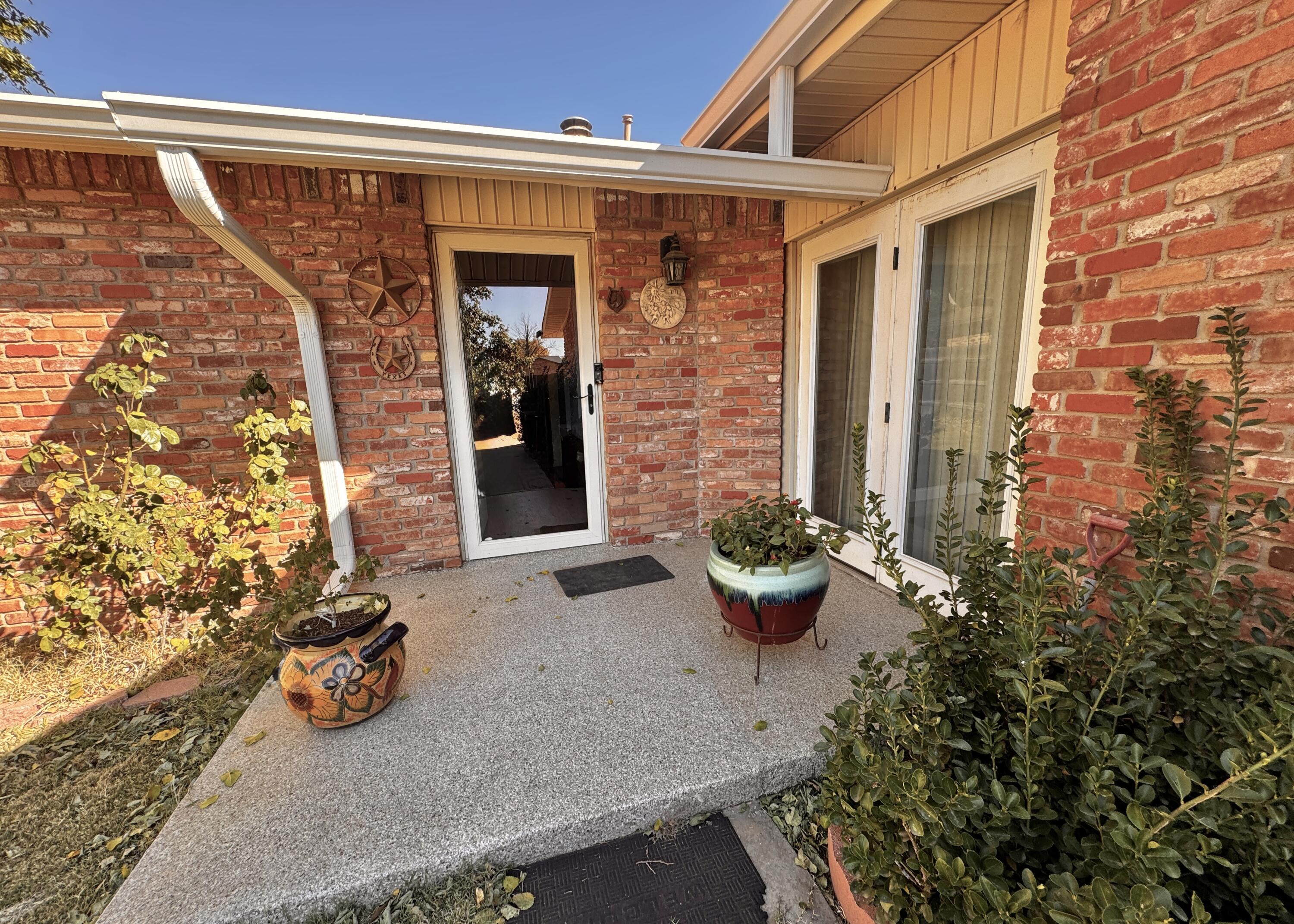 3902 Sides Street Plainview, TX 79072 - Photo 3 of 26 front view of a house with potted plants