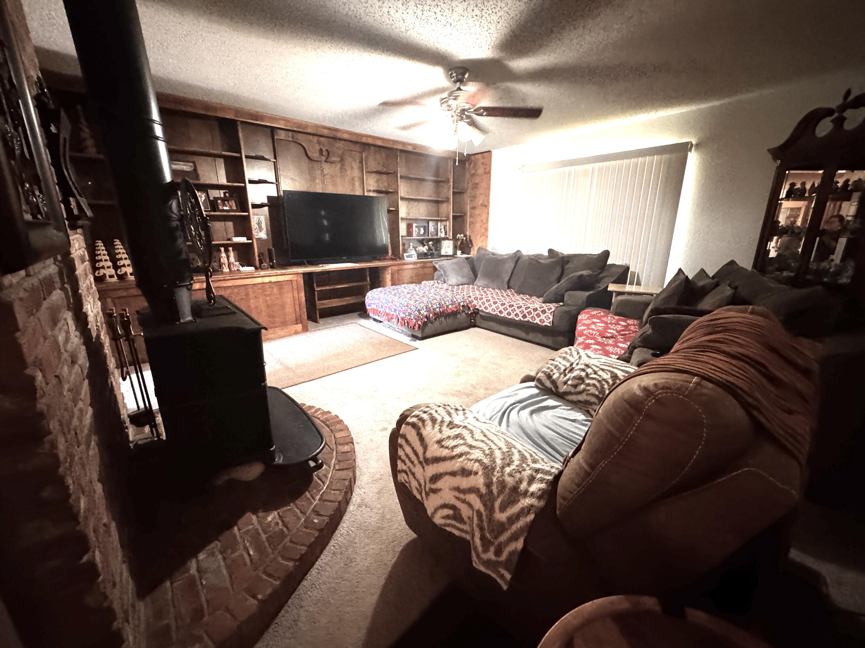 3902 Sides Street Plainview, TX 79072 - Photo 6 of 26 a large bedroom with a bed and flat screen tv