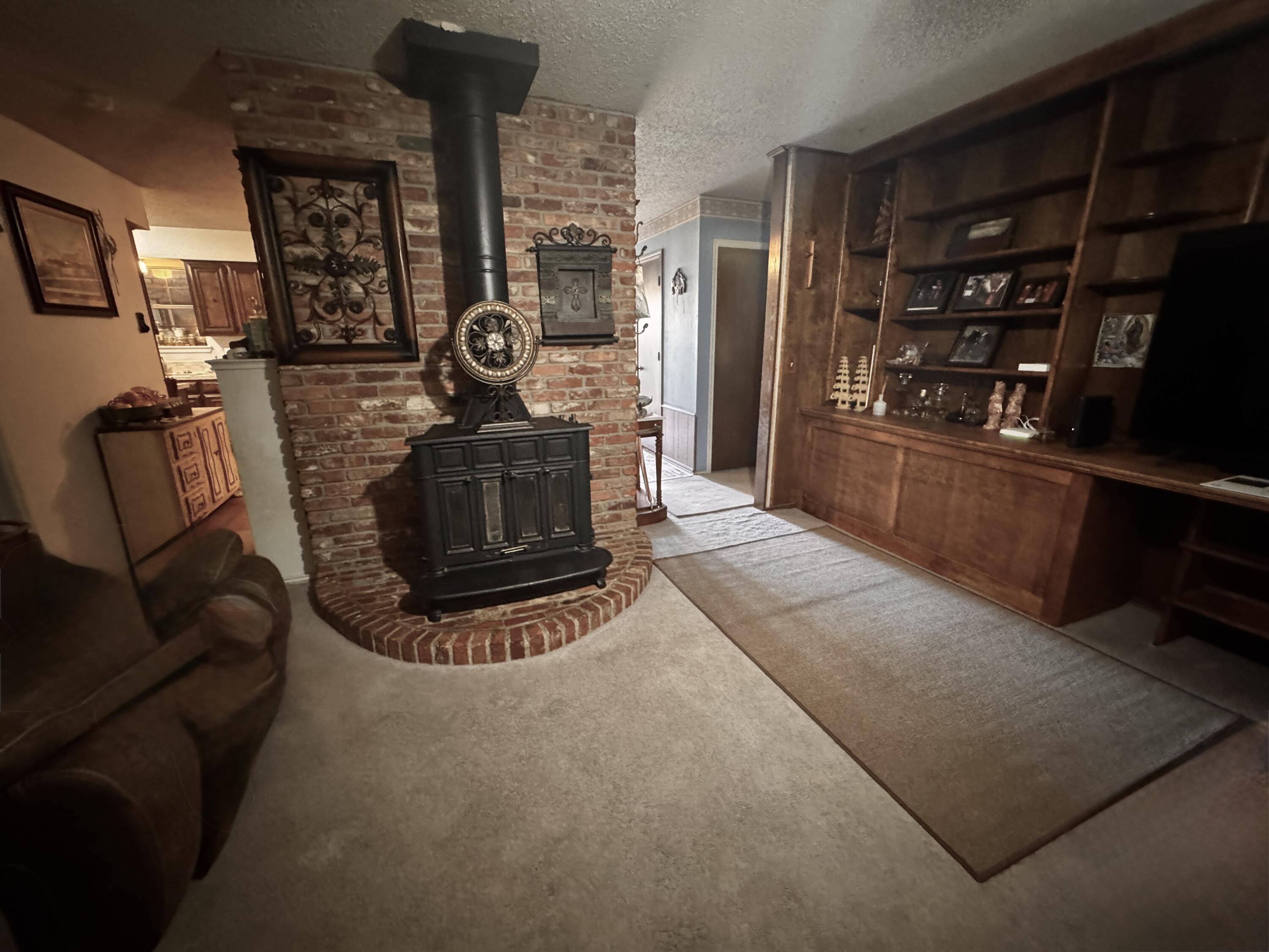 3902 Sides Street Plainview, TX 79072 - Photo 7 of 26 a living room with furniture a window and fire place