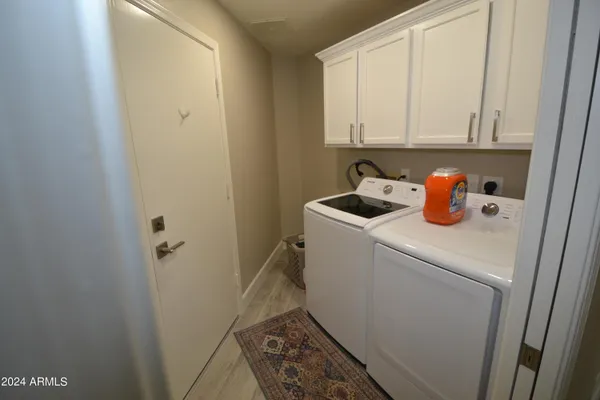 a outdoor living room with furniture and a rug