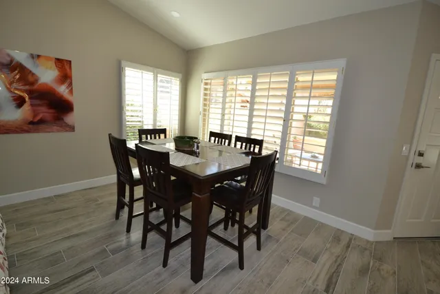 a view of a dining room with furniture and window