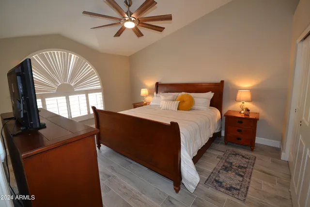 a bathroom with a granite countertop sink toilet and shower a mirror
