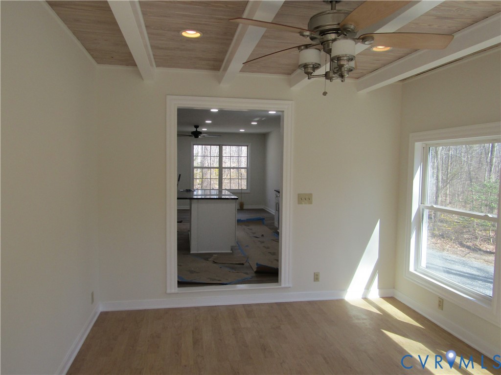 5705 Community House Road Columbia, VA 23038 - Photo 23 of 23 an empty room with chandelier fan and windows