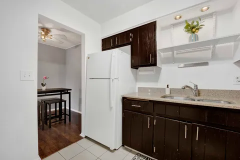 a kitchen with a sink cabinets and refrigerator