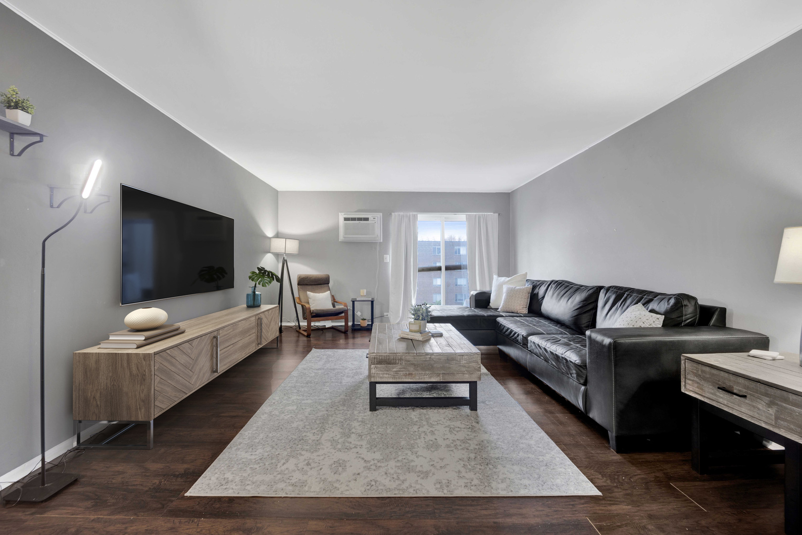 314 Lathrop Avenue, Unit 407 Forest Park, IL 60130 - Photo 2 of 27 a living room with furniture and a flat screen tv
