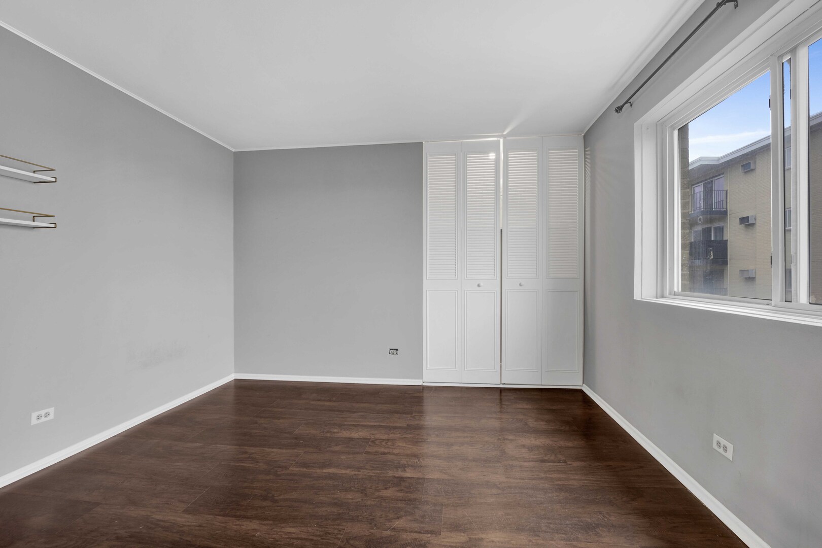 314 Lathrop Avenue, Unit 407 Forest Park, IL 60130 - Photo 21 of 27 a view of an empty room with wooden floor and a window