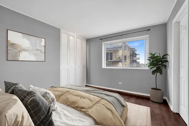 a bedroom with a bed and a potted plant