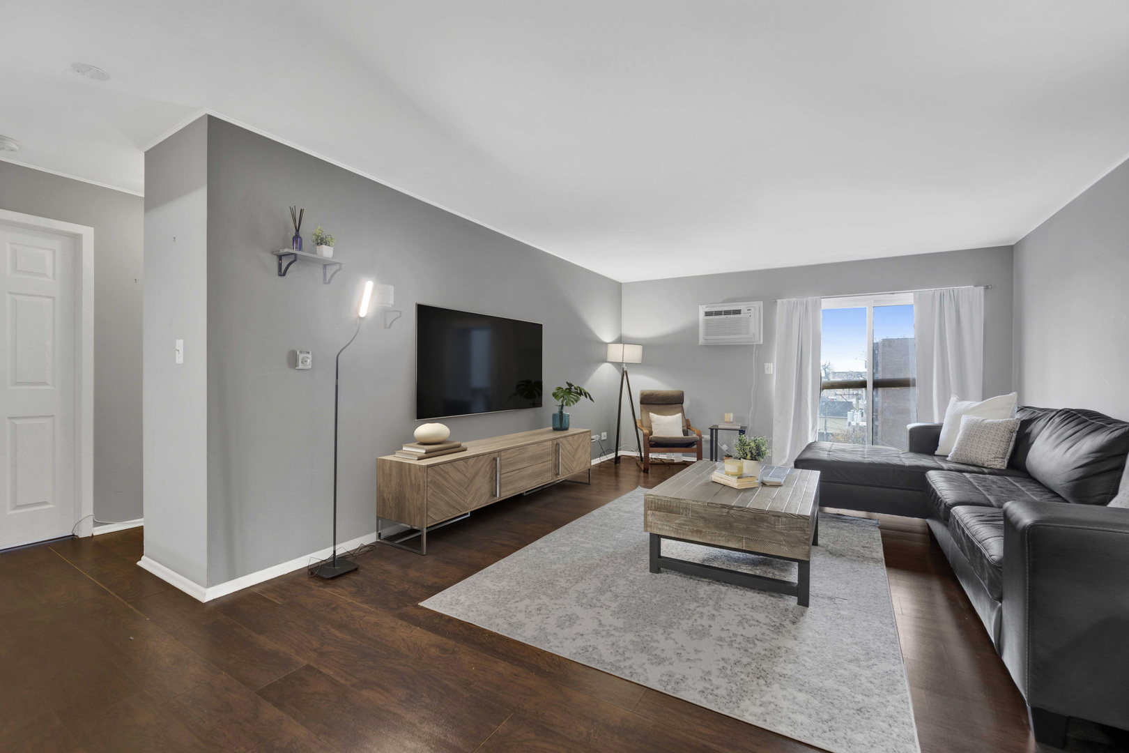 314 Lathrop Avenue, Unit 407 Forest Park, IL 60130 - Photo 3 of 27 a living room with furniture and a flat screen tv