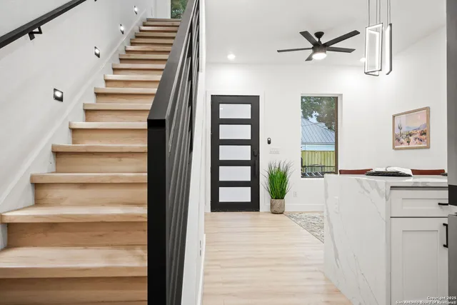 a view of a hallway with wooden floor and entryway