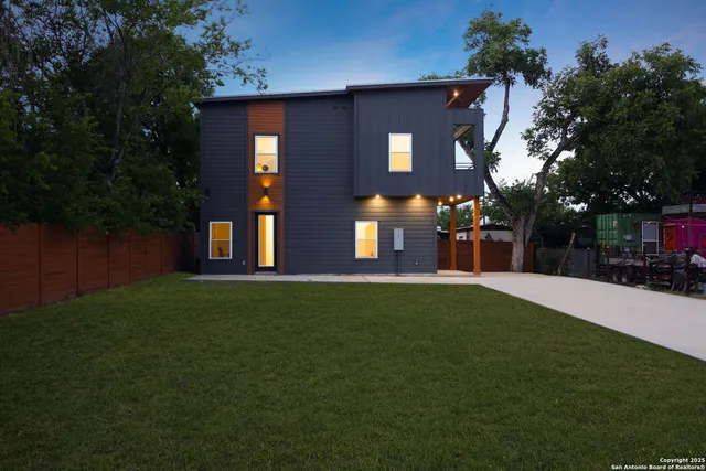 a front view of a house with a garden and yard