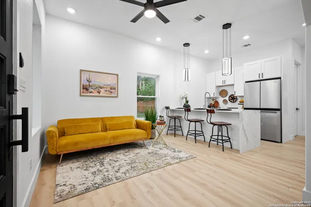 a living room with furniture and kitchen view