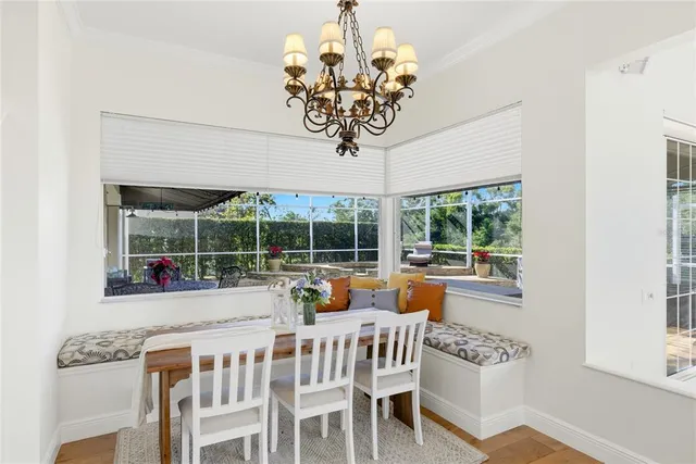a living room with furniture a fireplace and a chandelier