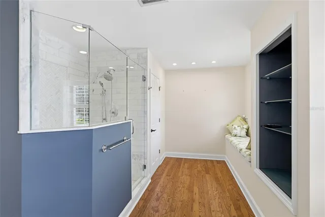 an empty room with a window and a ceiling fan