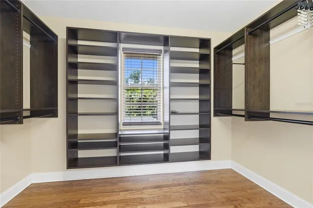 a bathroom with a granite countertop sink a toilet and mirror