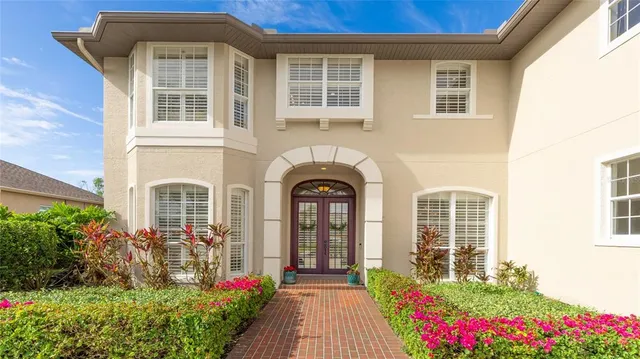 a front view of a house with a garden