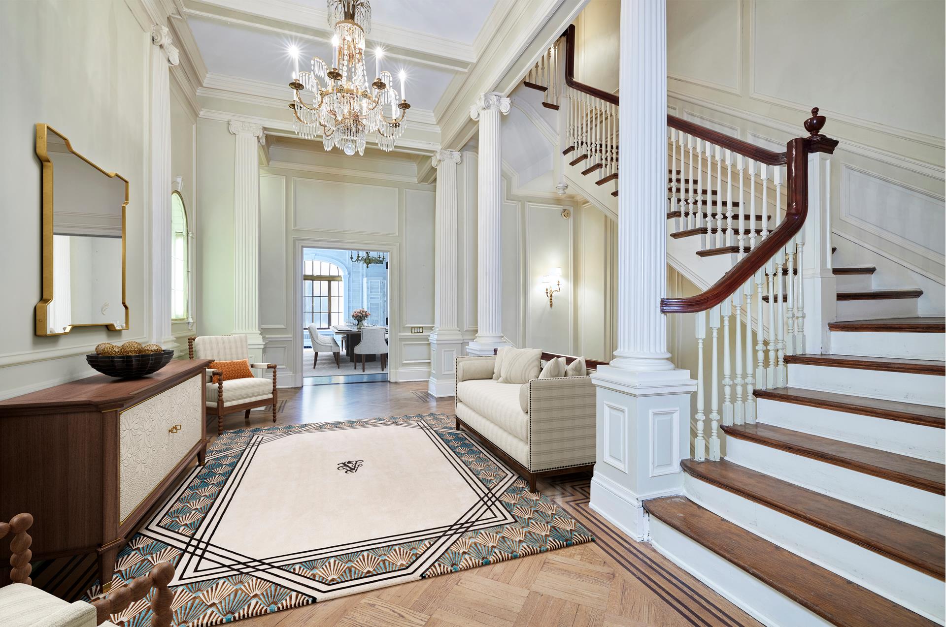 a living room with fireplace furniture and a chandelier