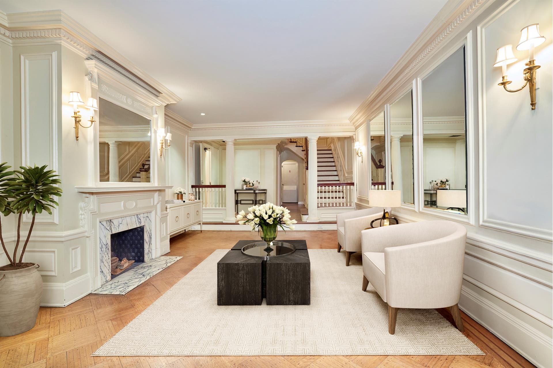 16 East 76th Street Manhattan, NY 10021 - Photo 9 of 12 a living room with furniture and a fireplace