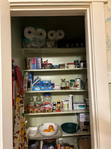 a shelf with cup and plates