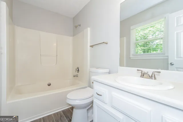 a bathroom with a sink a toilet and a bathtub