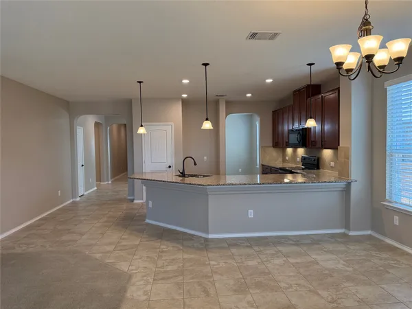 a view of kitchen with refrigerator and window