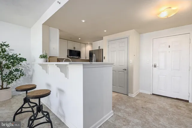 a kitchen with stainless steel appliances a refrigerator and a stove top oven