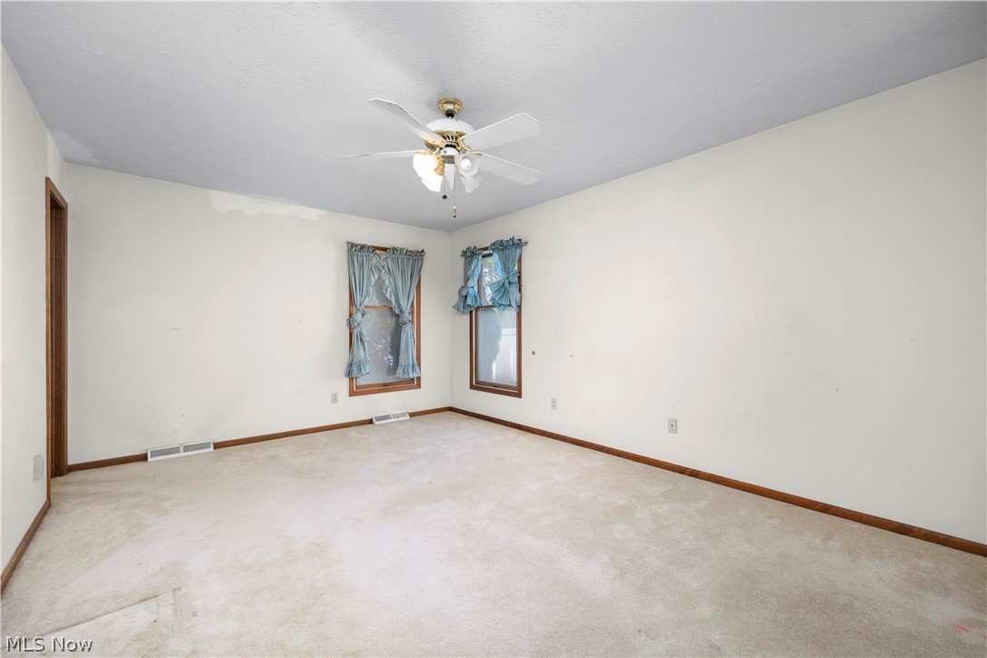 722 Jaycox Road Avon Lake, OH 44012 - Photo 22 of 48 Spacious room featuring neutral carpet, white walls, and wood-trim windows