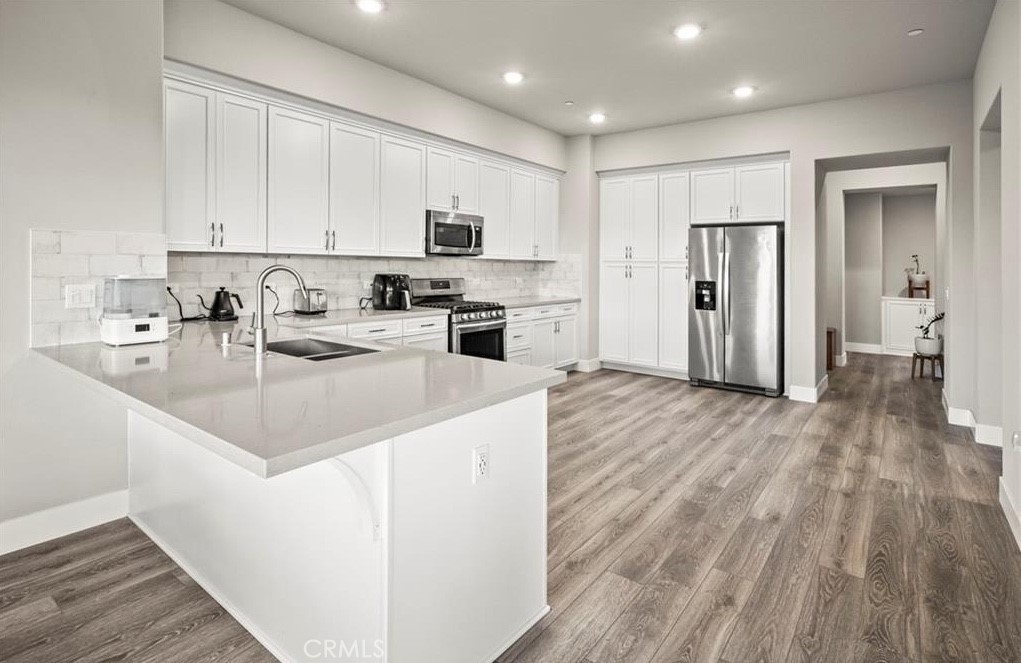 1661 Spring Street, Unit 444 Davis, CA 95616 - Photo 7 of 16 a kitchen with stainless steel appliances granite countertop a sink stove and refrigerator