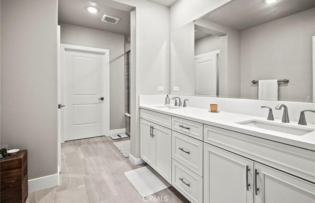 1661 Spring Street, Unit 444 Davis, CA 95616 - Photo 9 of 16 a spacious bathroom with a double vanity sink mirror and toilet
