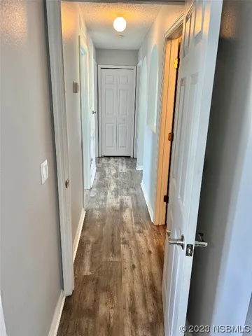 a bedroom with a bed a flat screen tv and a window