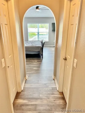 a view of an empty room with wooden floor