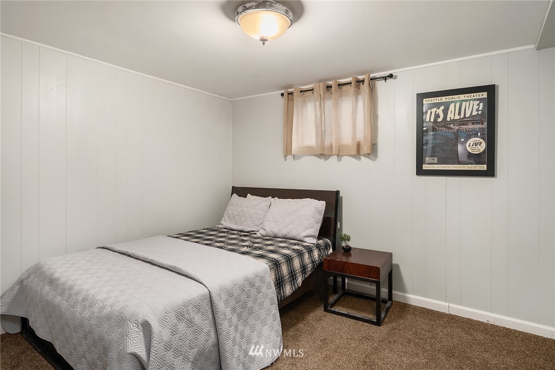 19607 Southeast 149th Street Renton, WA 98059 - Photo 25 of 34 a bedroom with a bed and a chandelier