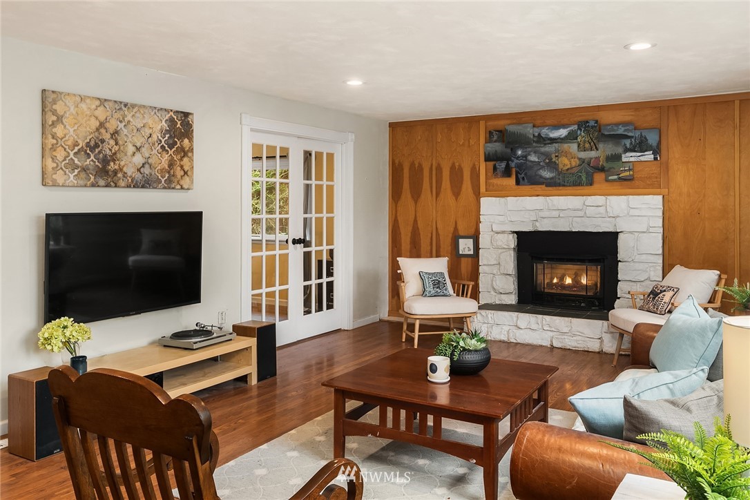 19607 Southeast 149th Street Renton, WA 98059 - Photo 9 of 34 a living room with furniture a flat screen tv and a fireplace