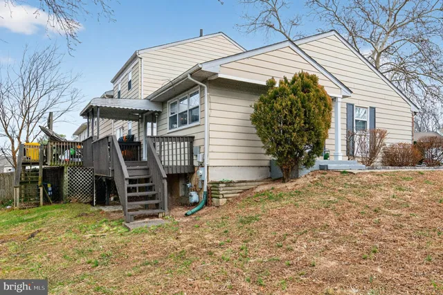 a view of a house with a yard and wooden fence