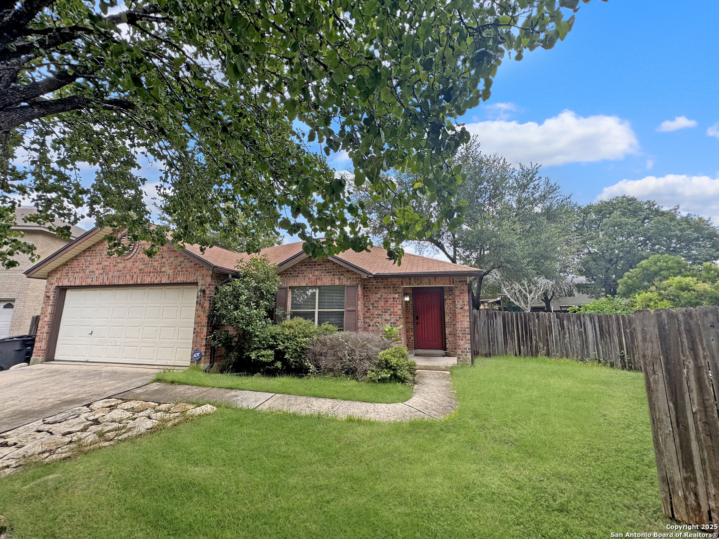 a front view of a house with a garden and yard