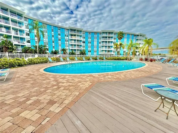 a view of a swimming pool with a yard