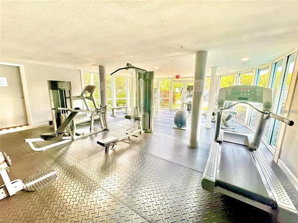 a living room with patio furniture and a large window