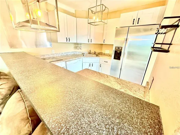 a view of a kitchen with a sink and wooden floor