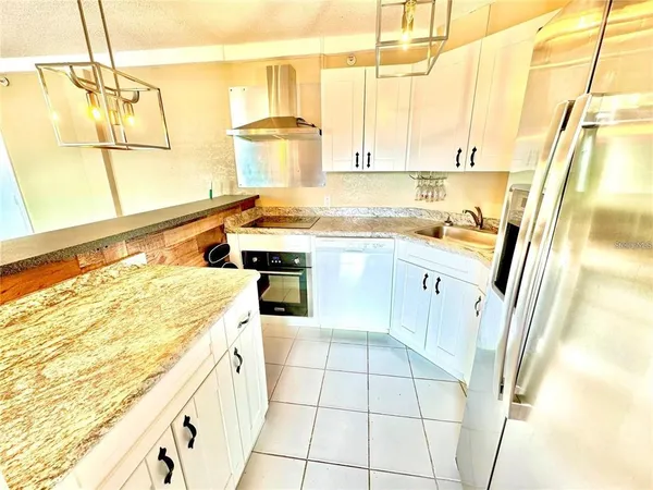 a kitchen with a sink a stove and cabinets