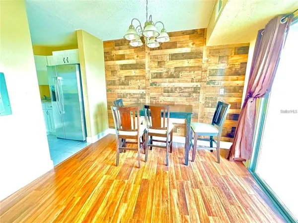 a view of a dining room with furniture and wooden floor