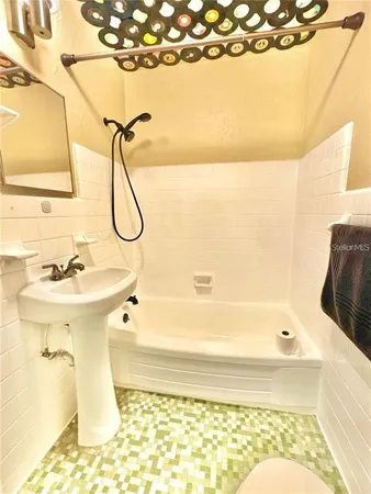 a bathroom with a sink mirror toilet and bathtub