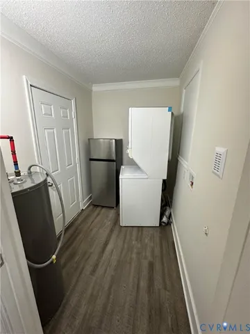 a view of a storage and utility room with refrigerator window