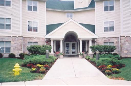 18400 Belvidere Road, Unit 320 Grayslake, IL 60030 - Photo 1 of 1 a front view of a house with a yard and potted plants